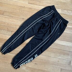 Black sweatpants with white stripes